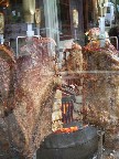 Meat cooking on a vertical rotisserie