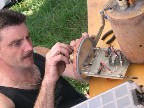 Threading the e-match into the powder charge receptacle.