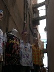 Fashionistas in the shadows of the common sight of structural supports between buildings.