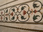 The inlay work is exquisite. If you shine a flashlight on the reddish stones, they glow orange as the light is conducted.